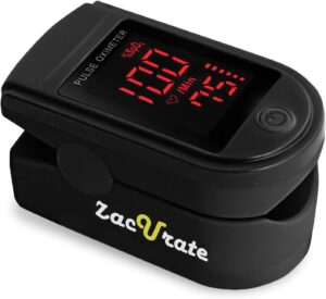 A black Zacurate pulse oximeter with a red digital display shows oxygen saturation, pulse rate, and a heart symbol. This Amazon wellness find features a power button and fits comfortably over your fingertip for easy health monitoring.