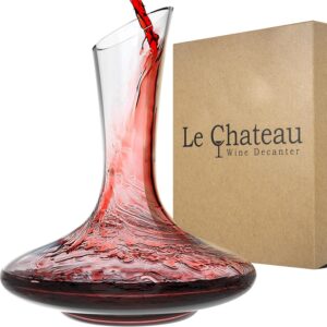 A glass wine decanter is being filled with red wine, with a brown box labeled Le Chateau Wine Decanter in the background—an essential wine tool for wine lovers.
