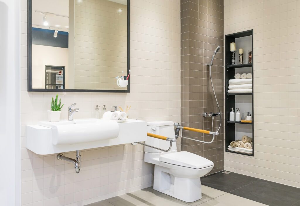 accessable bathoom with bars around toilet seat