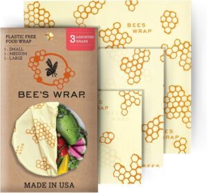 Bee’s Wrap reusable food wraps set with three assorted sizes, featuring a honeycomb and bee pattern. The packaging shows a small, medium, and large wrap covering a bowl of vegetables. Plastic Free Food Wrap.