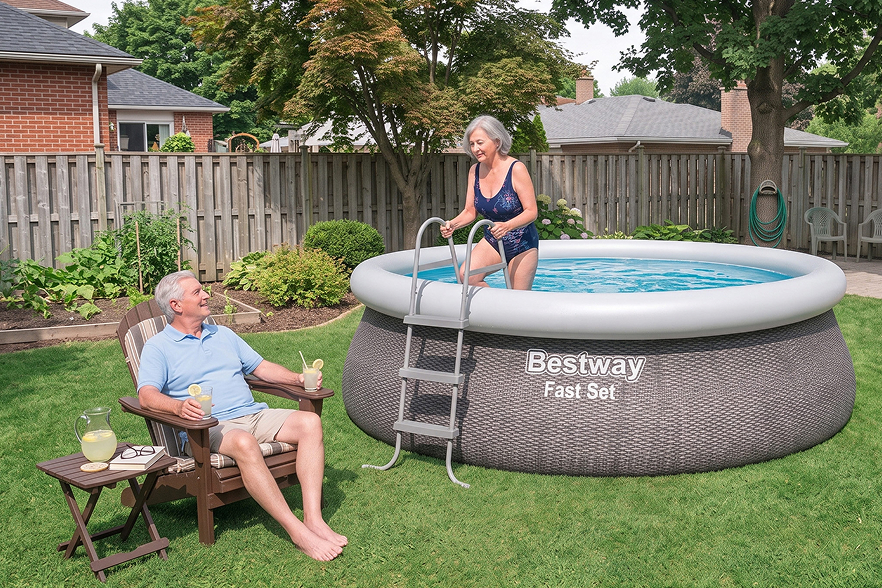 An older woman in a swimsuit climbs out of a round above-ground pool as an older man relaxes nearby, smiling and holding lemonade. The pool, labeled Bestway Fast-Set, showcases why it’s considered the best backyard pool for enjoying sunny days together in a lush green yard.
