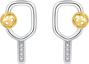 A pair of earrings shaped like pickleball paddles, with silver outlines, small clear stones on the handles, and gold pickleball-shaped balls attached to the side of each paddle.