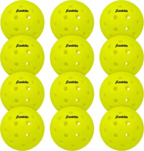 Twelve bright yellow pickleballs with evenly spaced holes, each displaying the Franklin logo in black text, arranged in a 4 by 3 grid on a white background.