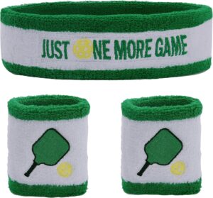A green and white headband with the text “Just One More Game” and two matching wristbands featuring a green paddle and yellow pickleball. All items are made of soft, absorbent material.