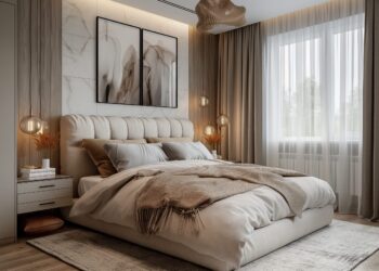 Modern bedroom with a plush bed, neutral bedding, soft throw blanket, bedside tables with lamps, abstract wall art, sheer curtains, and warm natural lighting from a large window reflects the latest bedroom design trends.