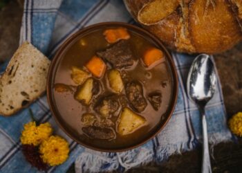 Hearty beef stew with bread and spoon