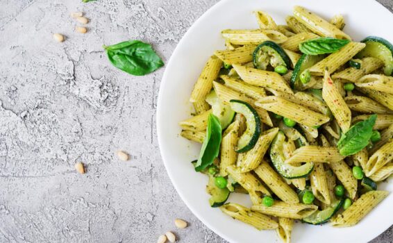 Penne pasta with zucchini and pesto sauce.