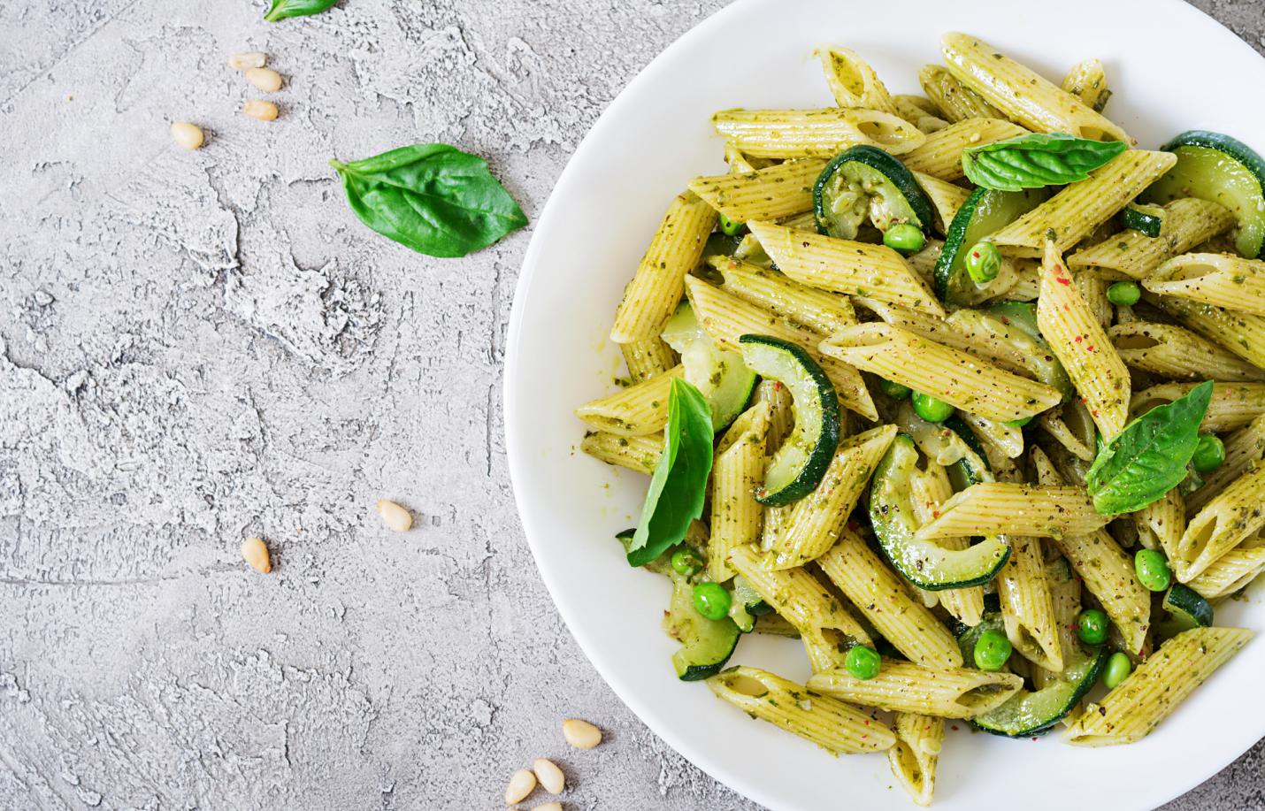 Penne pasta with zucchini and pesto sauce.
