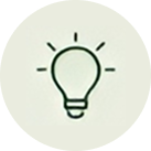 Simple black outline of a lightbulb with lines radiating from it, symbolizing an idea or inspiration, centered on a light gray circular background—perfect for an About ZestYears page or lifestyle site for older adults seeking fresh perspectives.