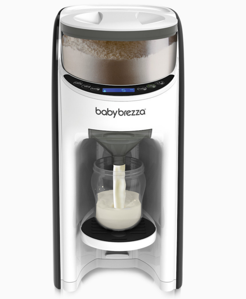 A Baby Brezza formula dispenser automatically preparing a bottle of formula, with milk flowing into a baby bottle positioned on the machine’s tray.