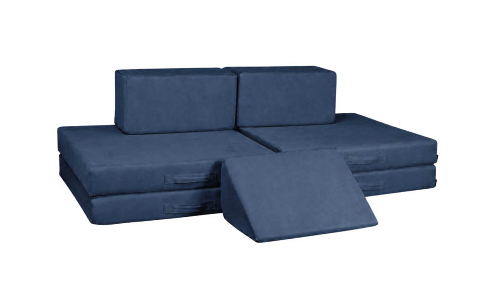 A modular navy blue floor sofa with two rectangular back cushions, two seat cushions arranged flat, and one wedge-shaped cushion leaning in front.