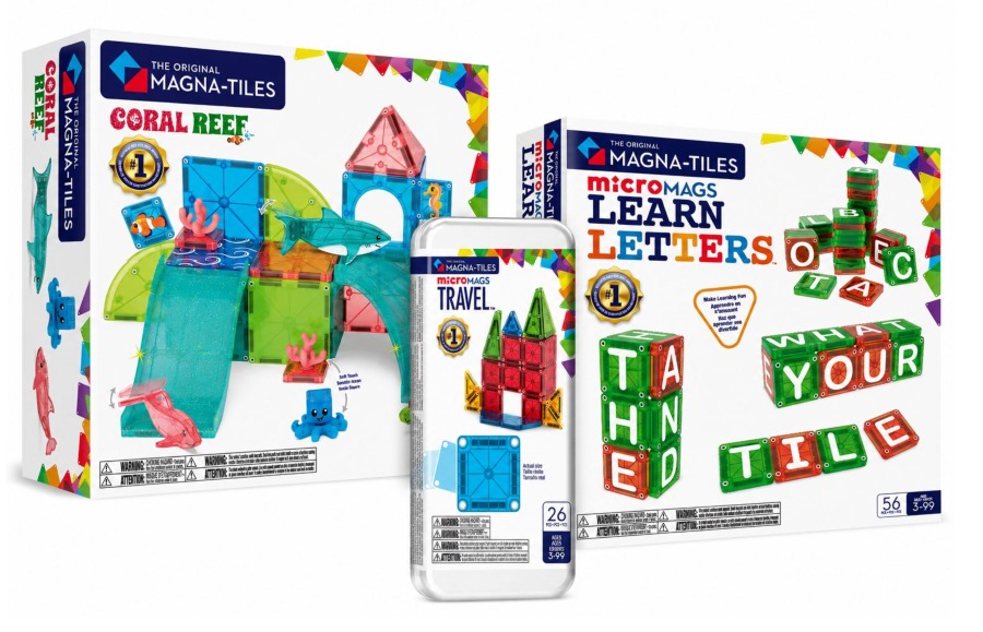 Three Magna-Tiles toy sets are shown: Coral Reef, MicroMags Learn Letters, and a Travel set. The packaging displays colorful magnetic building tiles and playful designs for childrens educational play.
