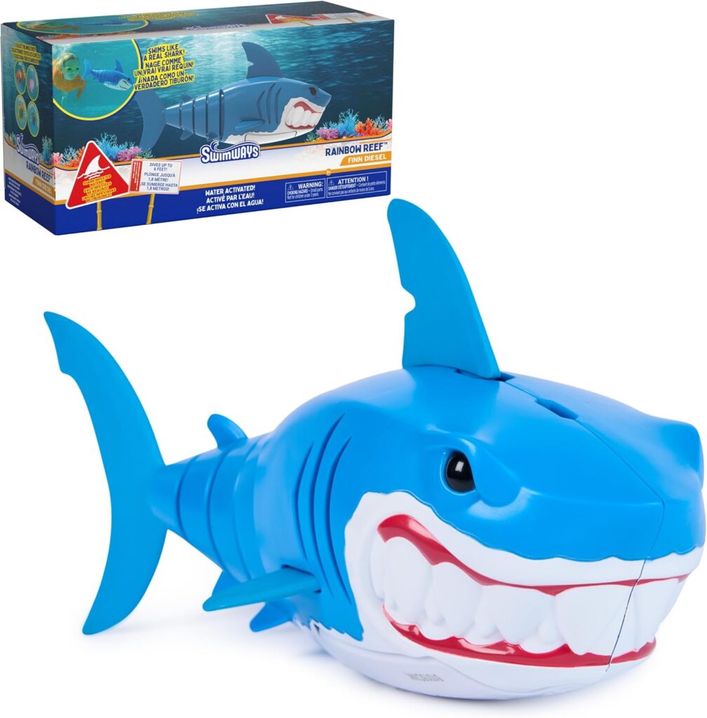 A blue and white toy shark with large teeth and a big smile is shown, making it a perfect choice for kid-friendly outdoor gifts. Its colorful packaging features ocean graphics and product details, highlighting its fun design.