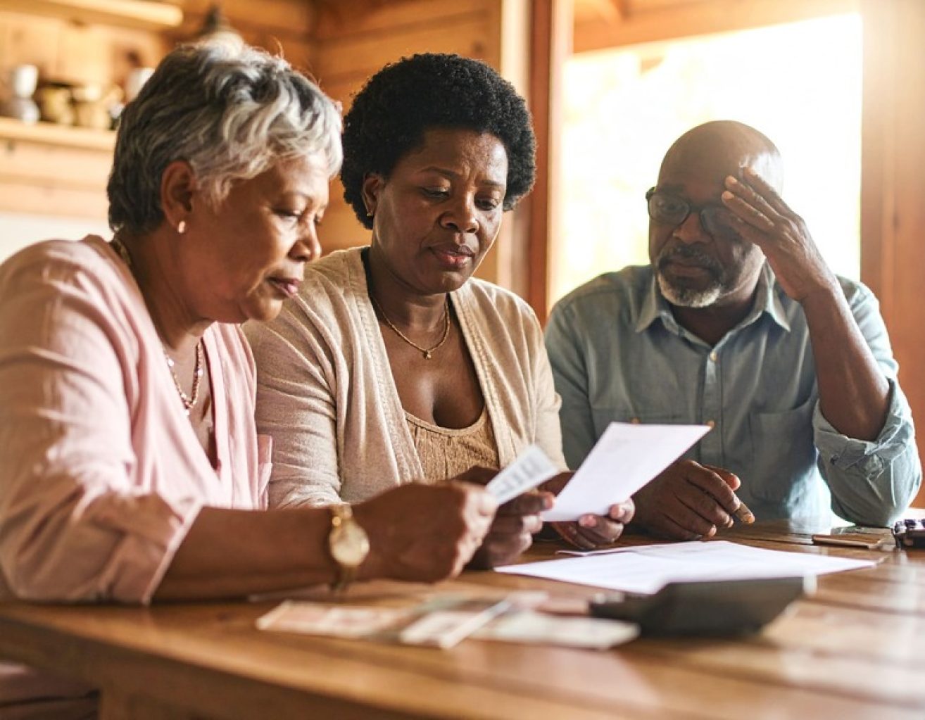 PAYING ADULT CHILDRN’S BILLS African AMerican family discussing finances